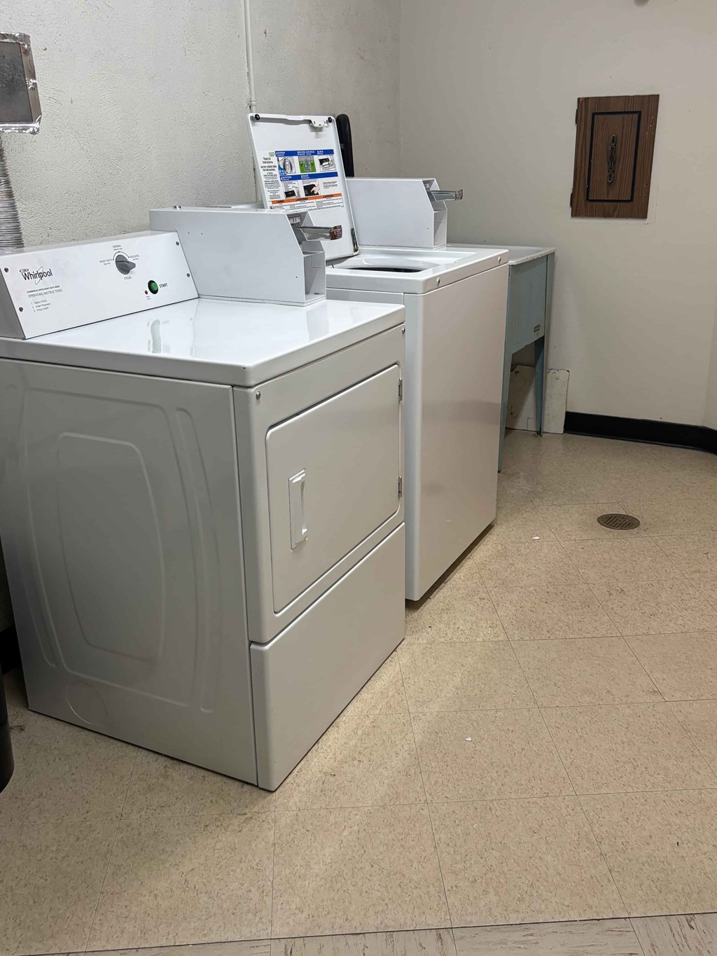 A white washing machine and dryer in a laundry room.