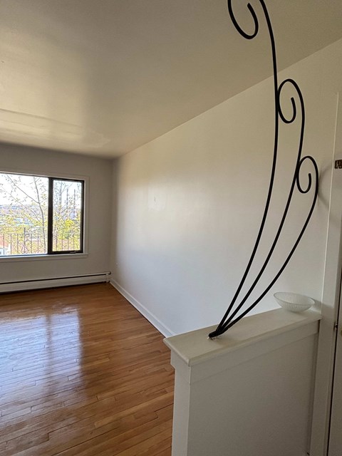 A room with a wooden floor and a metal railing.