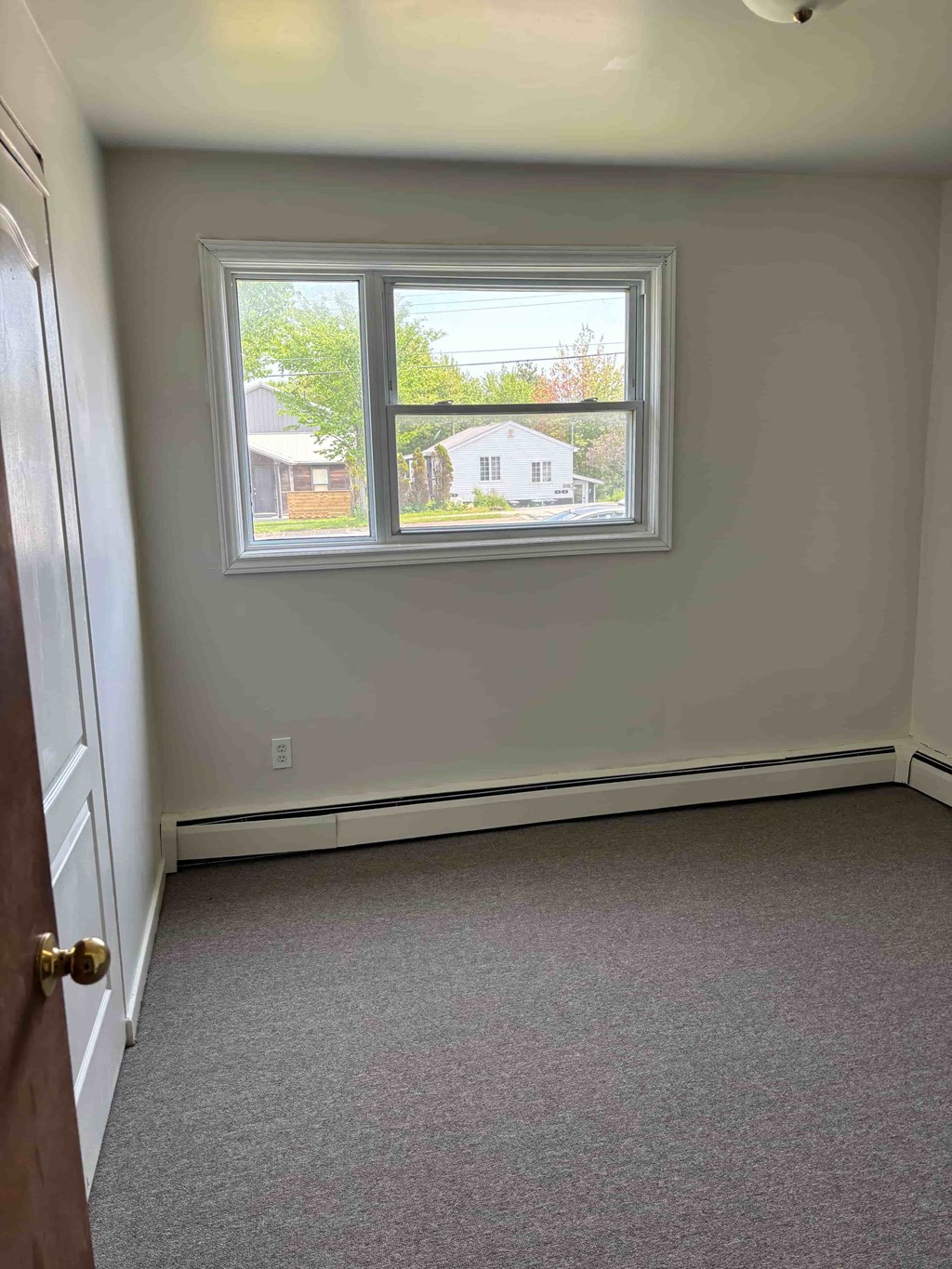 A room with a window and a door.