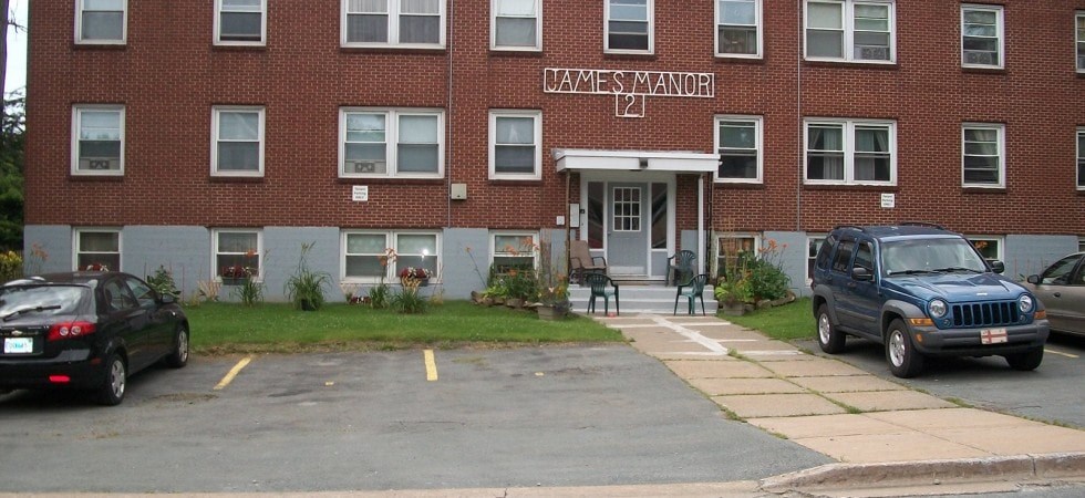 A brick building with the name James Manor on it.