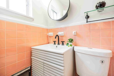 A bathroom with a white sink and a white bathtub.