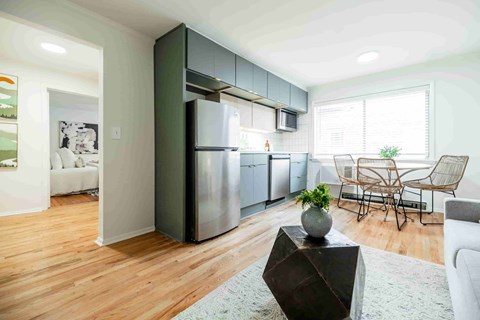 A modern kitchen with a wooden floor and a large island.