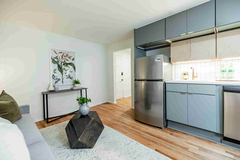 A modern kitchen with a refrigerator, oven, and cabinets.