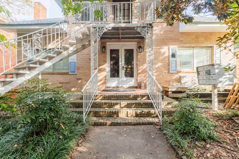 A house with a staircase leading to the front door.