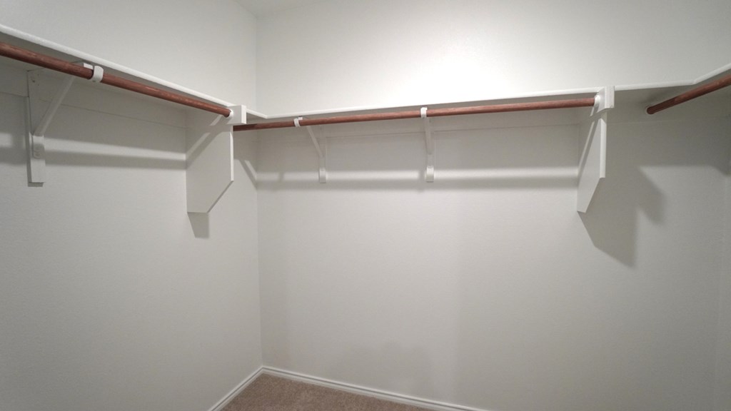 A white wall with a coat rack.
