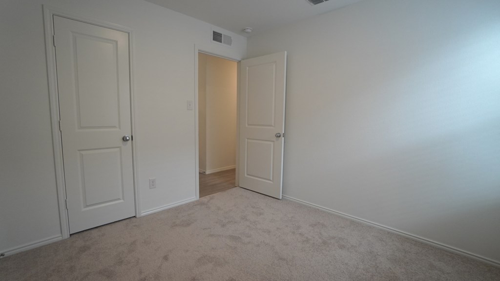 A room with two doors, one of which is open.