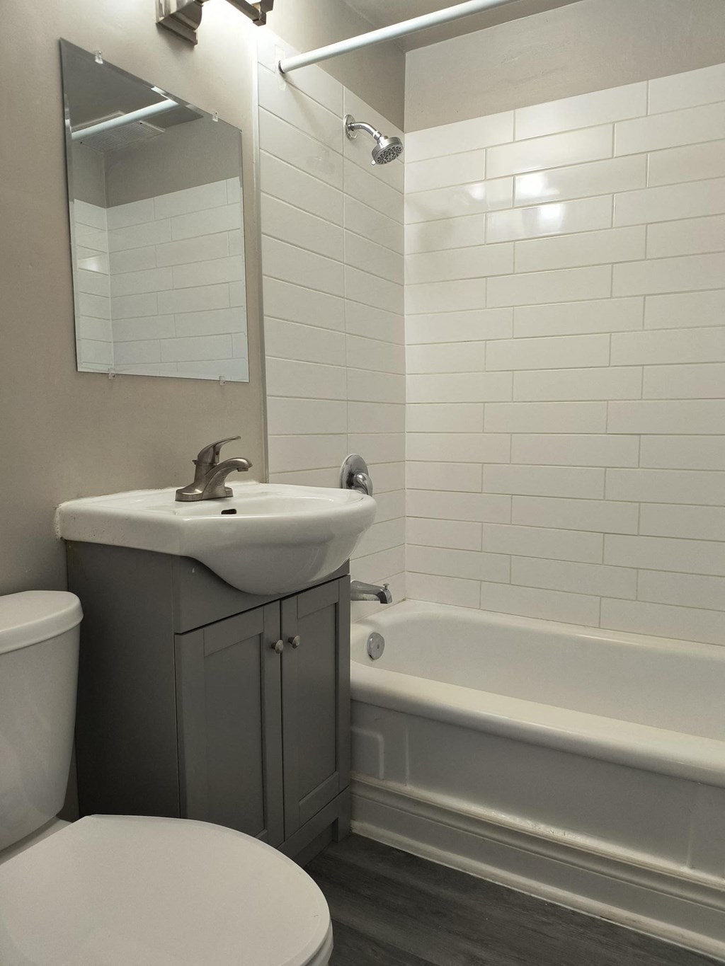 A white toilet sits next to a sink in a bathroom.