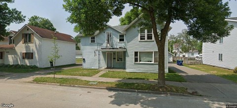 a white house on the corner of a street