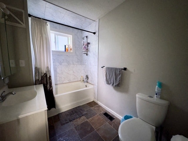 a bathroom with a toilet and a tub and a sink