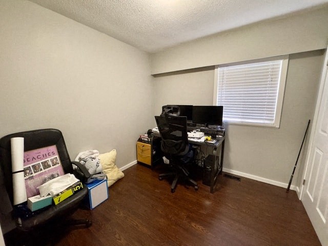 a small room with a desk and a window