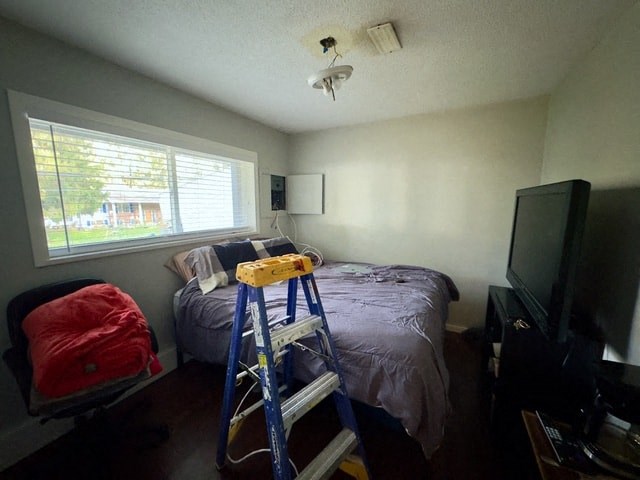 a room with a ladder and a bed and a window