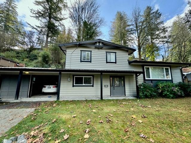 a white house with a yard and a car garage