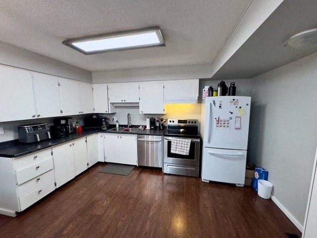 a kitchen with white cabinets and a stove and a refrigerator