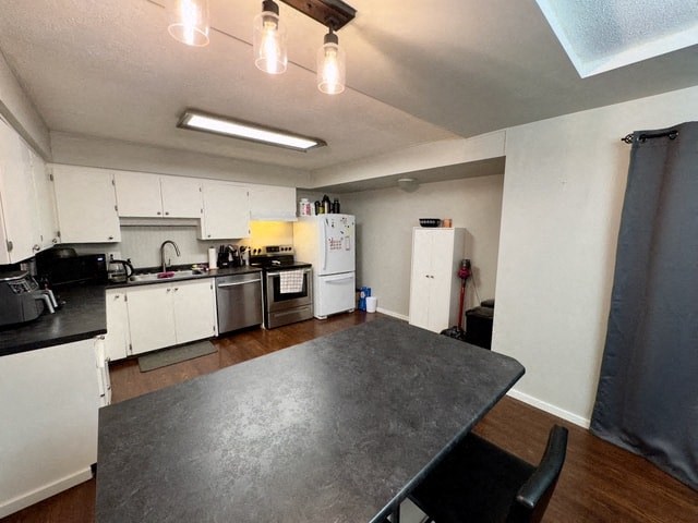 a kitchen with white cabinets and a table