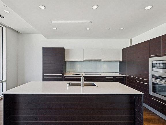 a kitchen with a white counter top and