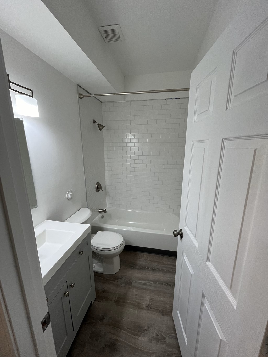 a small bathroom with a toilet and a tub and a sink