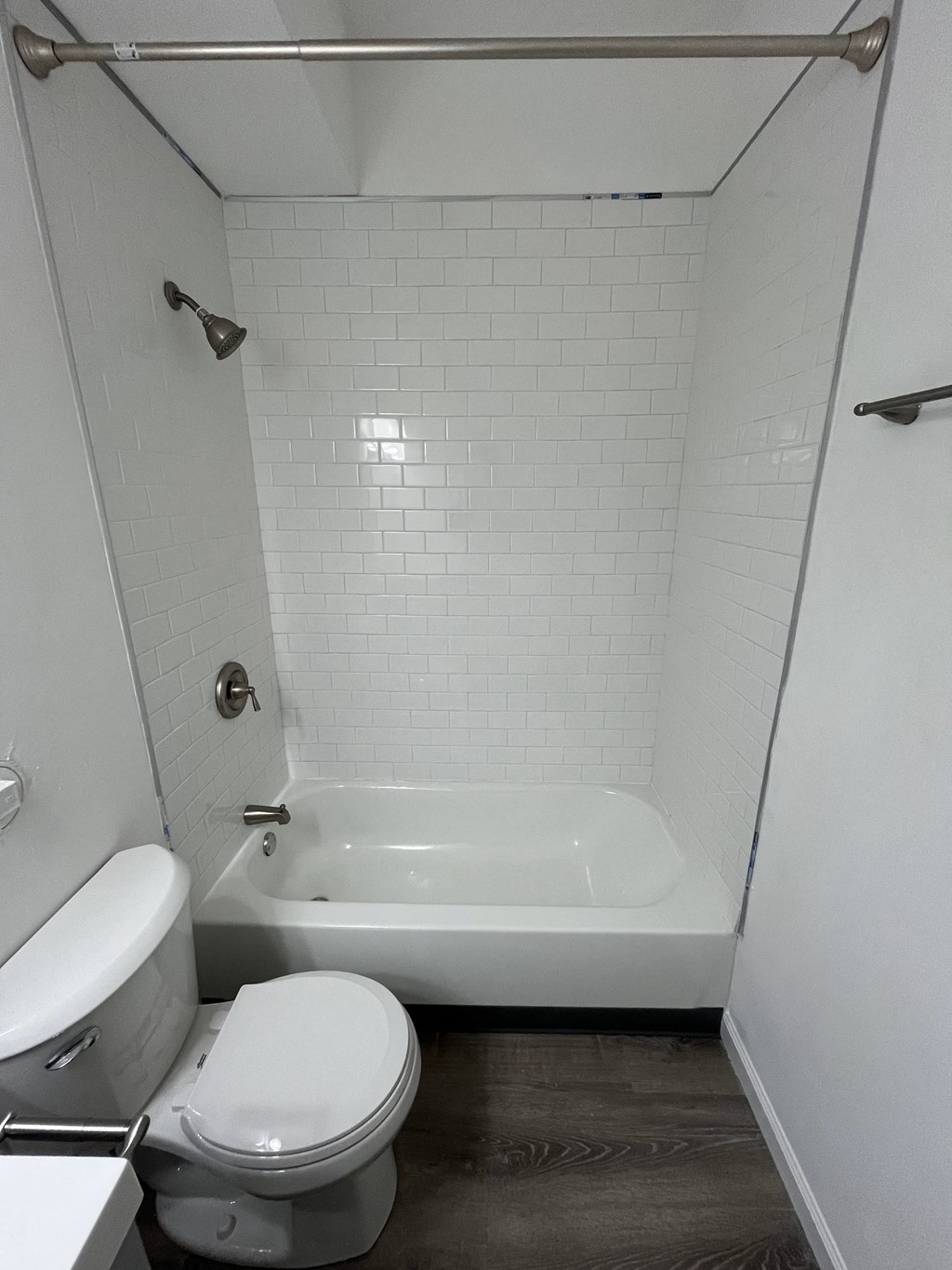 a small bathroom with a toilet and a bath tub