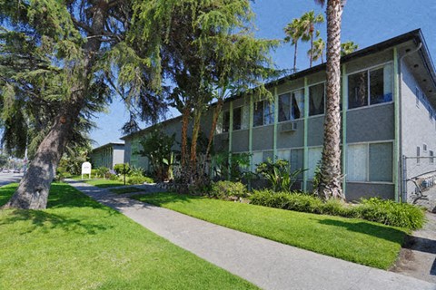 A building with a green lawn in front of it.