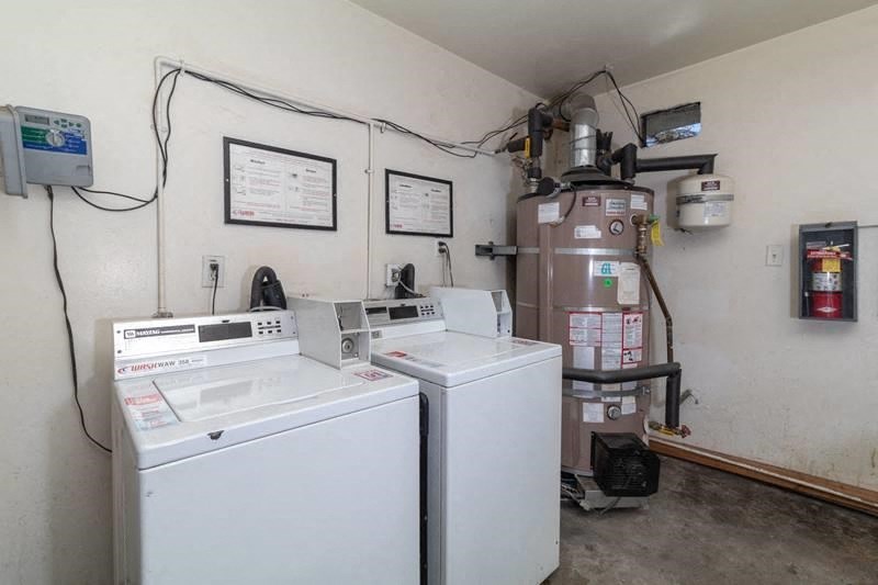 the laundry room has two washes and two dryers in it