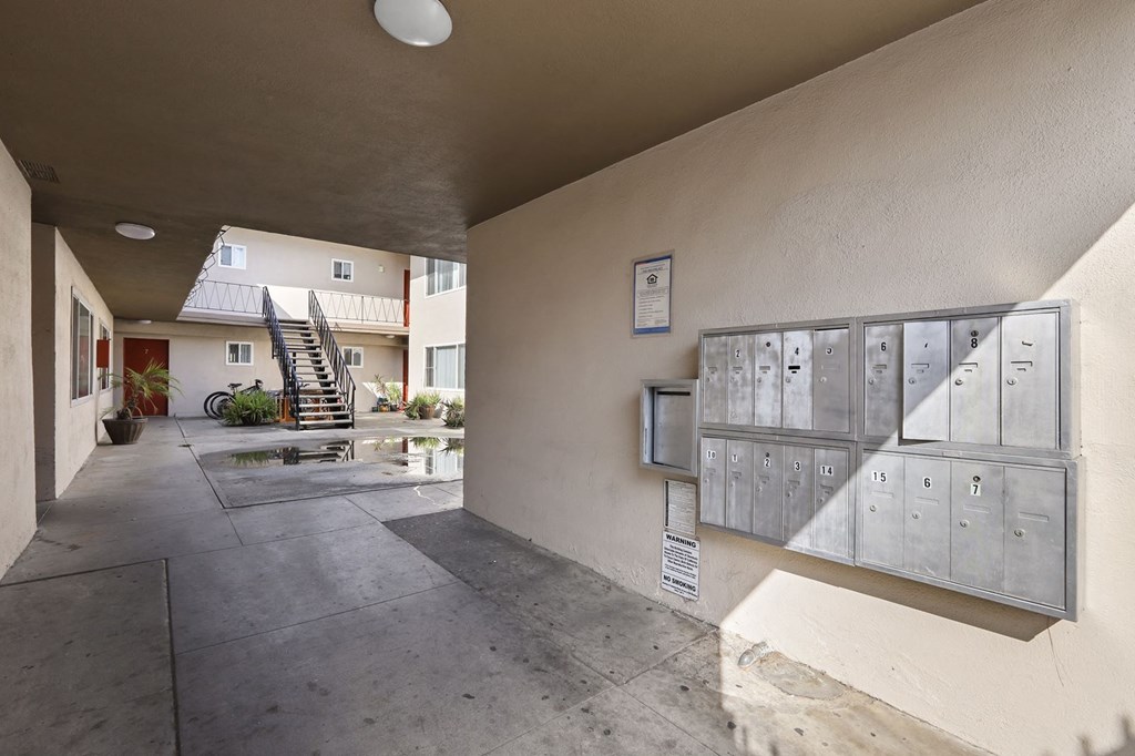 A hallway with a mailbox on the wall.