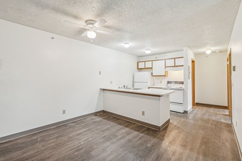 A kitchen with white cabinets and a wooden island.