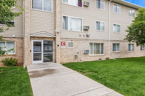 A building with a grey facade and a red cross on the front.