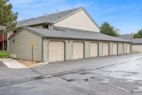 A building with a grey roof and a yellow sign on the side.