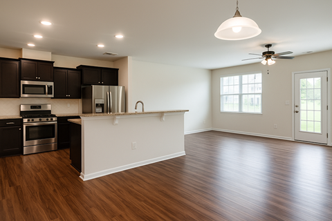 A kitchen with dark wood cabinets and a white island.
