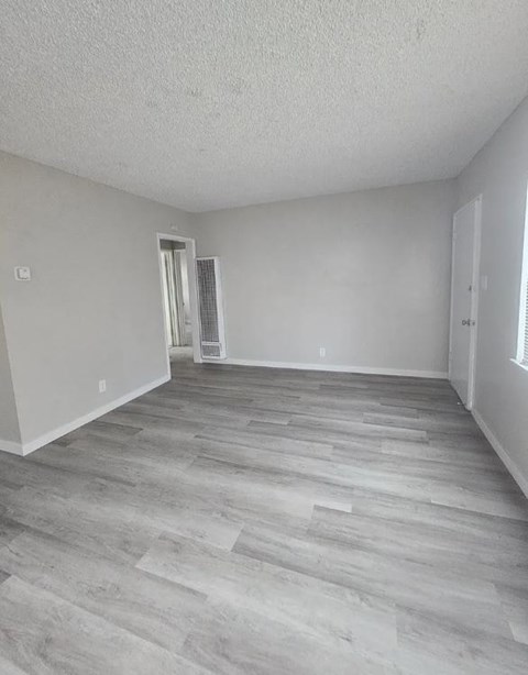 A room with a grey floor and white walls.