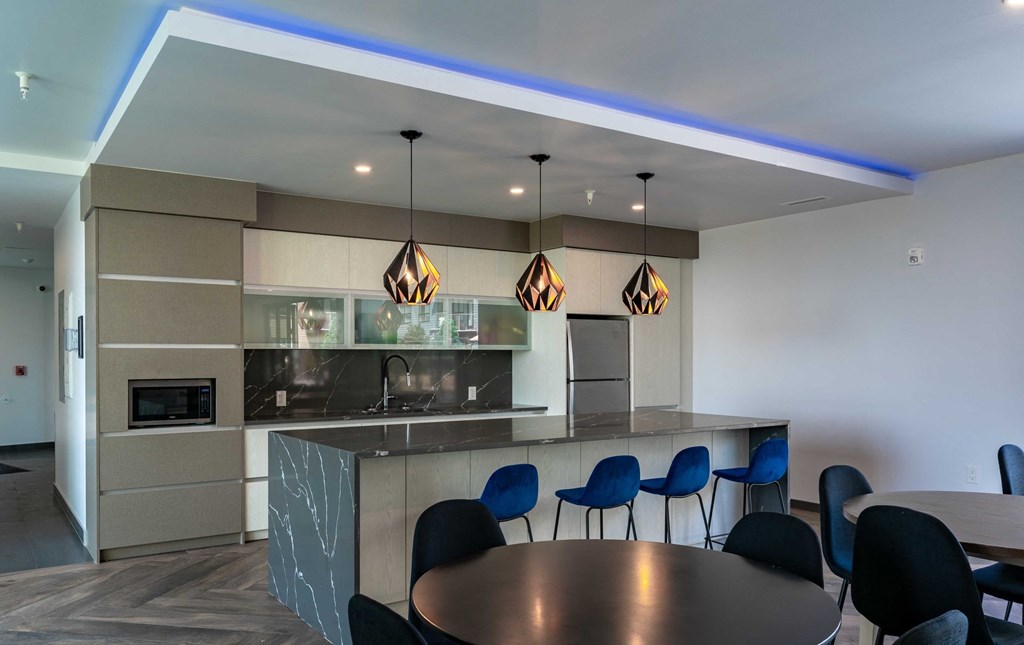 A modern kitchen with a dining table and chairs.