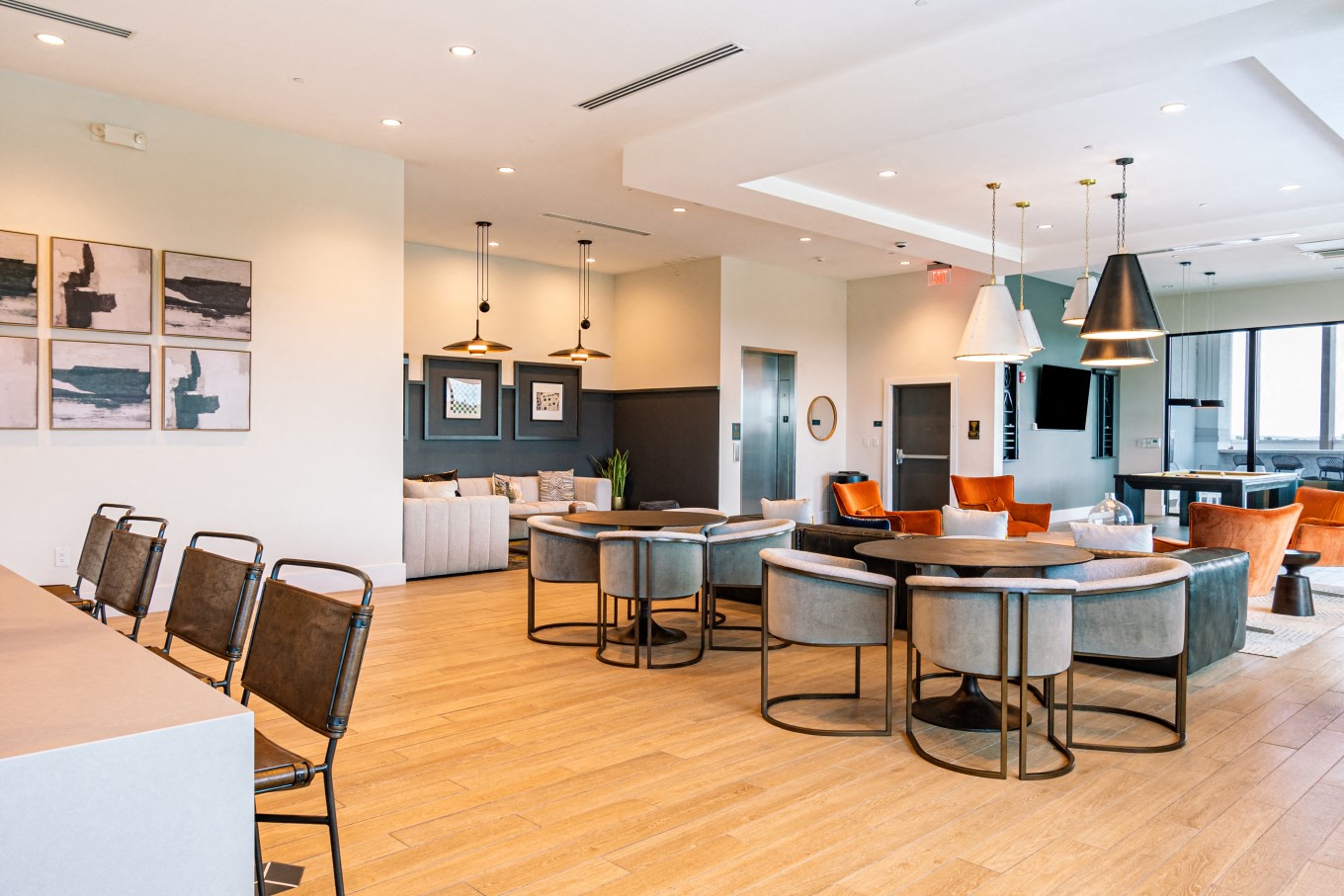 a dining room with tables and chairs and a living room