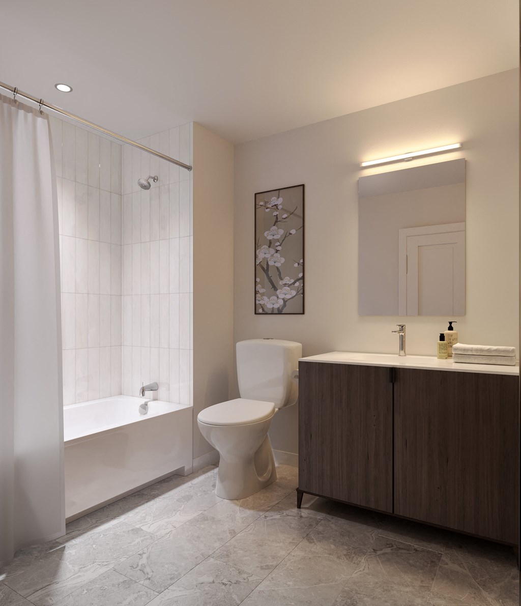 a bathroom with a toilet and a tub and a sink