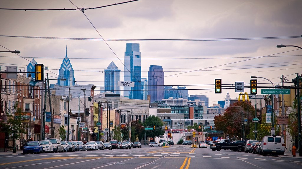 a city street with traffic lights and buildings in the background