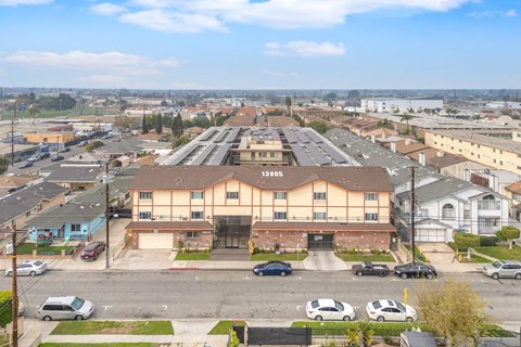 A parking lot with cars and a building with a sign that says "Torrance".