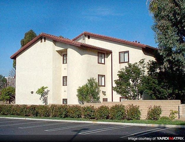 a large white house with a street in front of it