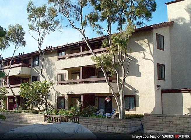 a large white building with trees in front of it