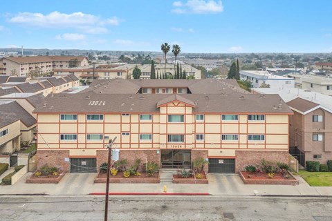 A large apartment complex with a red roof and a sign that reads 15828.