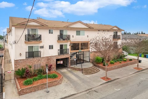 A large apartment building with a courtyard in front.