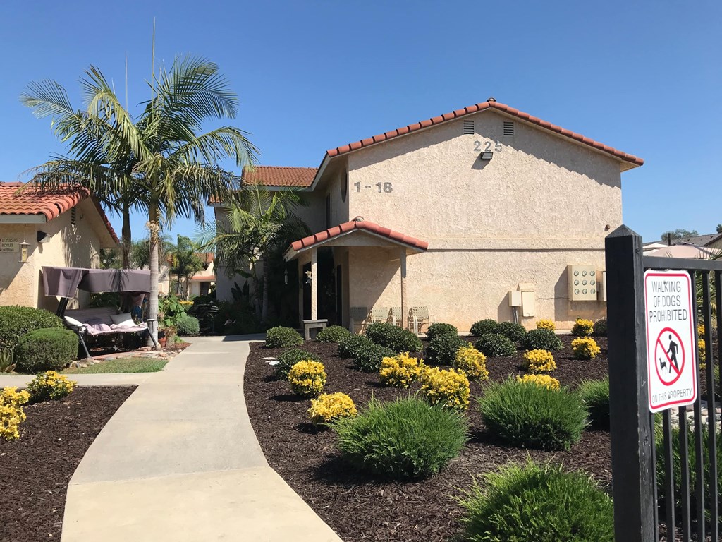 A sign on a fence states that dogs are not allowed.