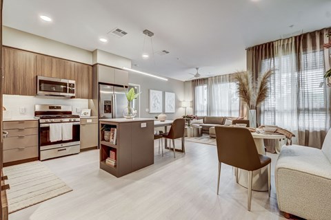 A modern kitchen with a dining area and a living room.