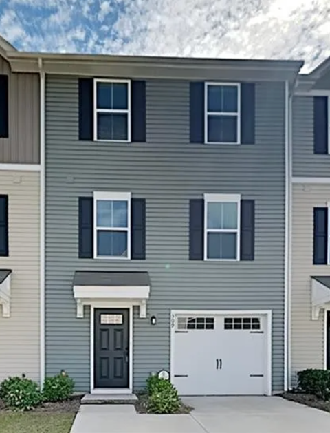 a gray house with a white garage door