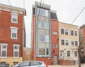 a tall brick building with a tall glass window