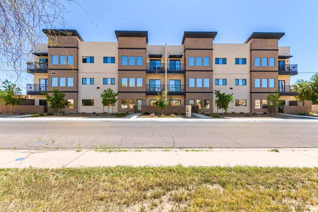 A large apartment building with multiple balconies and windows.