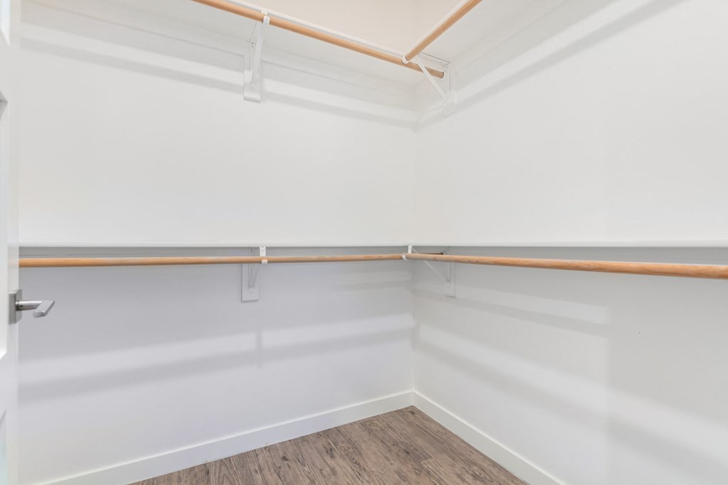 A white wall with a brown trim and a white door.