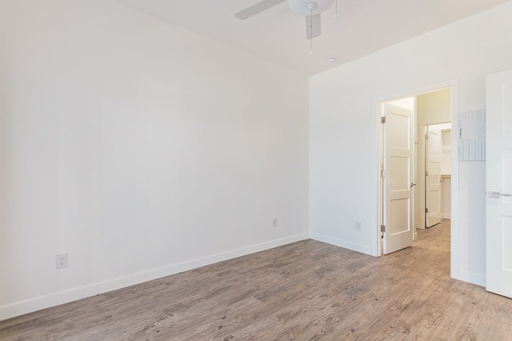 A room with a wooden floor and white walls.