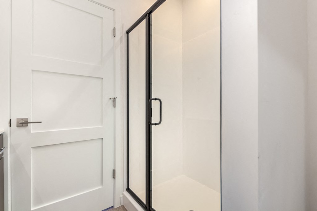 A white door is open to a glass door.