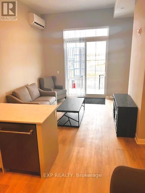 A living room with a dining table and chairs.