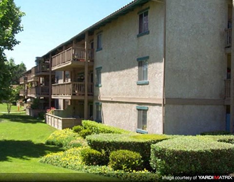 A building with a green lawn in front of it.