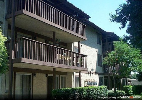 A building with a balcony and a sign that says "BAR".