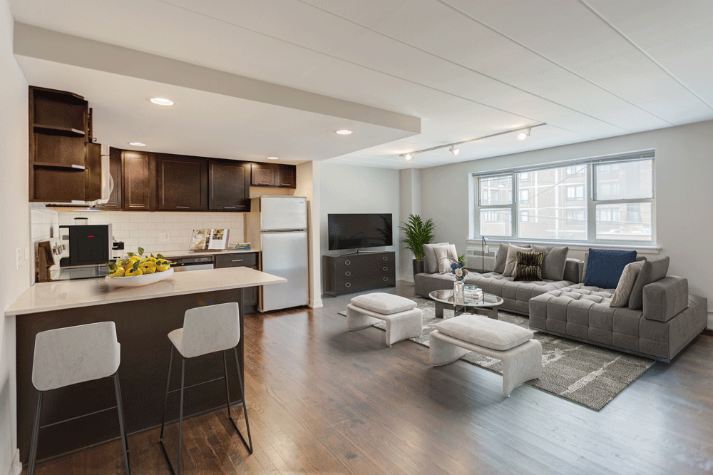 a living room with a kitchen and a couch